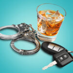 Whiskey with car keys and handcuffs concept for drinking and dri