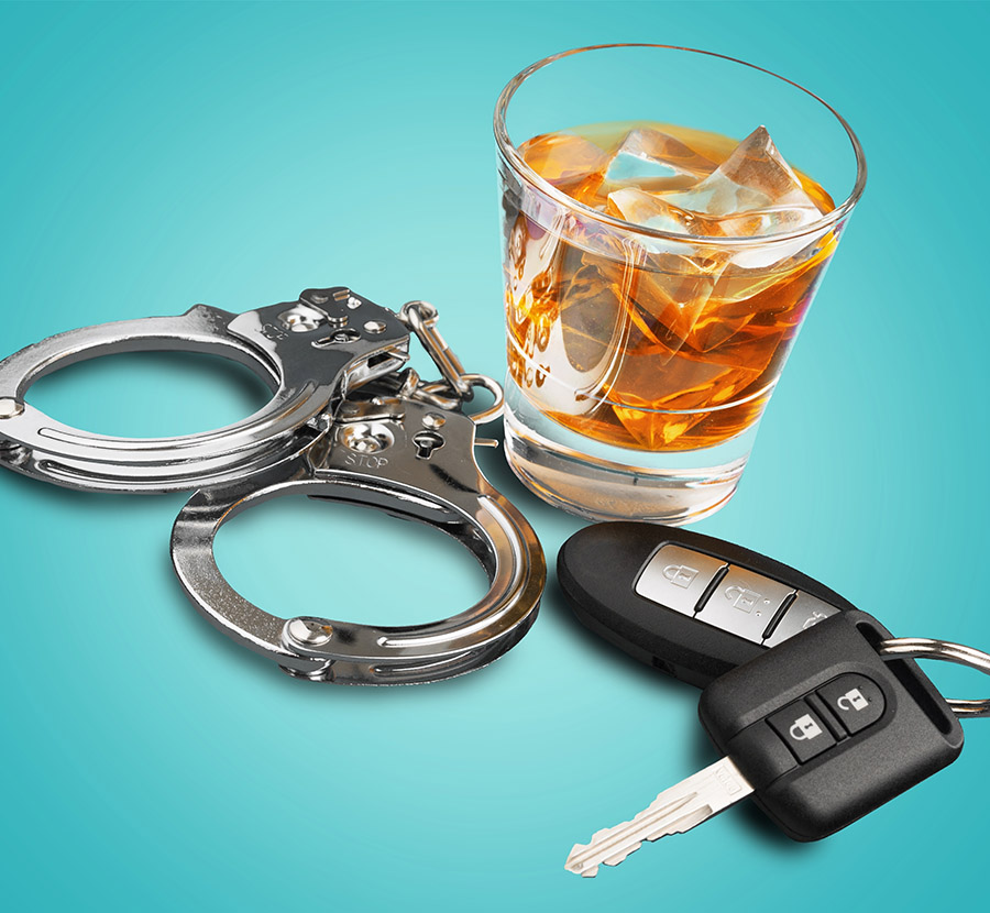 Whiskey with car keys and handcuffs concept for drinking and dri